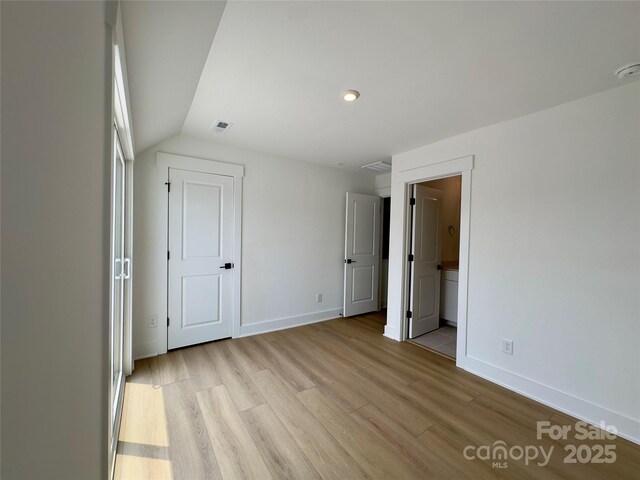 6013 Countess Dr Unit 51, Charlotte, NC 28217 - unfurnished bedroom featuring light wood finished floors, baseboards, and lofted ceiling