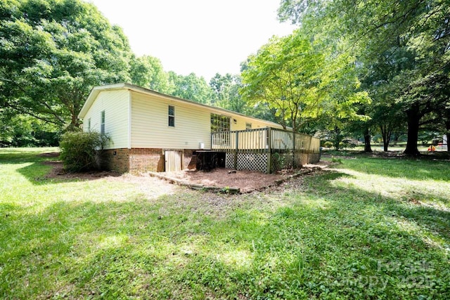 155 Springdale Acres Dr, Mooresville, NC 28115 - view of property exterior featuring a wooden deck, a lawn, cooling unit, and view of scattered trees