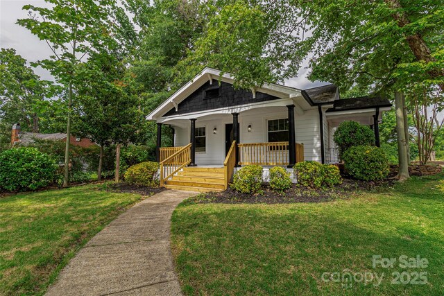 940 N New Hope Rd, Gastonia, NC 28054 - bungalow-style home featuring a porch and a front lawn