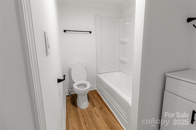 940 N New Hope Rd, Gastonia, NC 28054 - bathroom with toilet, wood finished floors, crown molding, baseboards, and washtub / shower combination