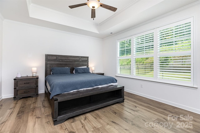 482 Lucky Dr NW, Concord, NC 28027 - bedroom featuring a raised ceiling, wood finished floors, crown molding, and ceiling fan