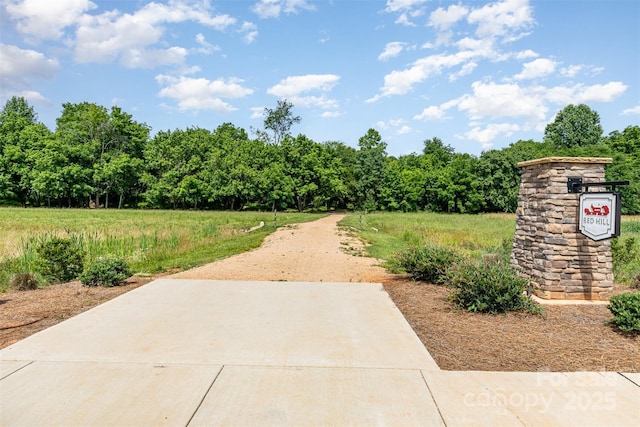 482 Lucky Dr NW, Concord, NC 28027 - view of home's community with a forest view and a patio area