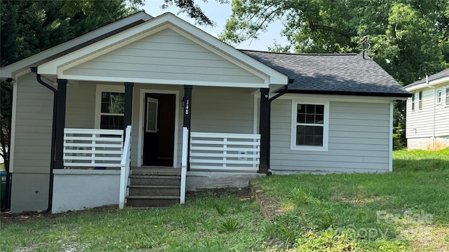 148 Forest Heights Dr, Mcadenville, NC 28101 - bungalow with roof with shingles, a front yard, and covered porch