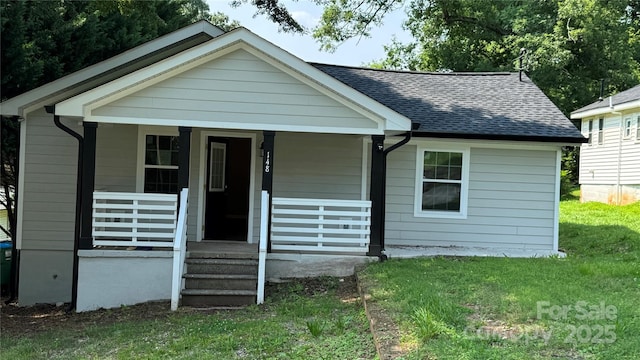 148 Forest Heights Dr, Mcadenville, NC 28101 - bungalow-style house with a shingled roof, a porch, and a front yard