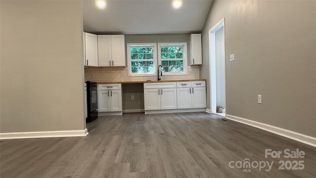 148 Forest Heights Dr, Mcadenville, NC 28101 - kitchen featuring tasteful backsplash, white cabinetry, baseboards, stove, and vaulted ceiling
