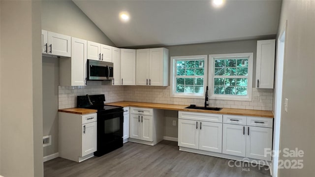 148 Forest Heights Dr, Mcadenville, NC 28101 - kitchen featuring butcher block countertops, black / electric stove, a sink, stainless steel microwave, and lofted ceiling