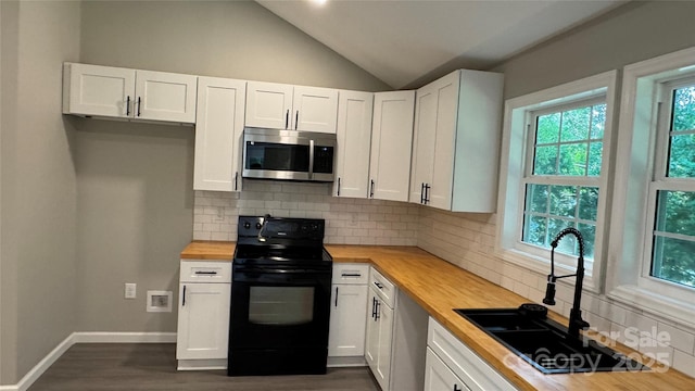 148 Forest Heights Dr, Mcadenville, NC 28101 - kitchen with stainless steel microwave, black range with electric cooktop, wooden counters, a sink, and lofted ceiling