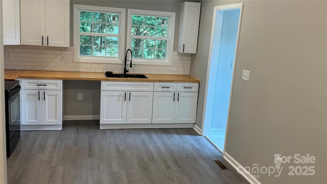 148 Forest Heights Dr, Mcadenville, NC 28101 - kitchen with butcher block countertops, a sink, electric range, white cabinets, and light wood-style floors