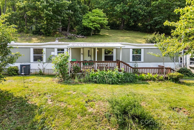 355 Dix Creek Rd, Leicester, NC 28748 - manufactured / mobile home featuring a front lawn, covered porch, and cooling unit