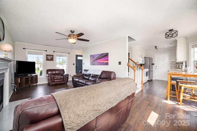 600 Capella Ct, Gastonia, NC 28056 - living area featuring a ceiling fan, dark wood-type flooring, stairs, ornamental molding, and a textured ceiling