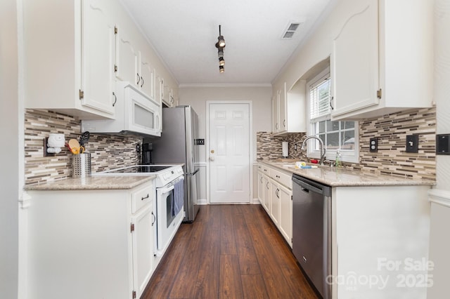 600 Capella Ct, Gastonia, NC 28056 - kitchen featuring appliances with stainless steel finishes, white cabinets, decorative backsplash, dark wood finished floors, and crown molding