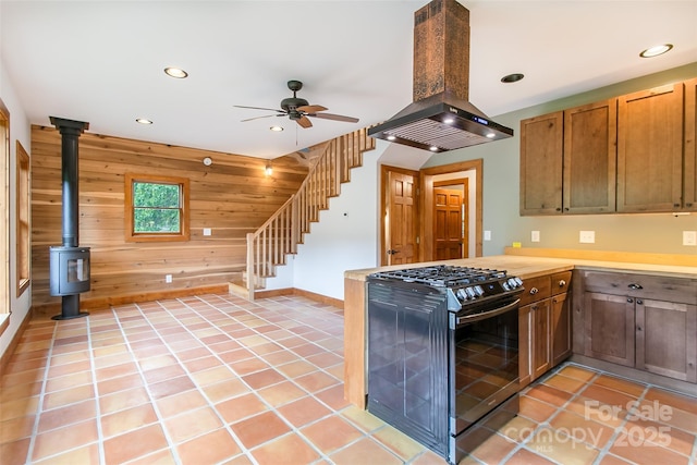 1146 Thomas Branch Rd, Marshall, NC 28753 - kitchen with gas range, island range hood, wood walls, recessed lighting, and ceiling fan