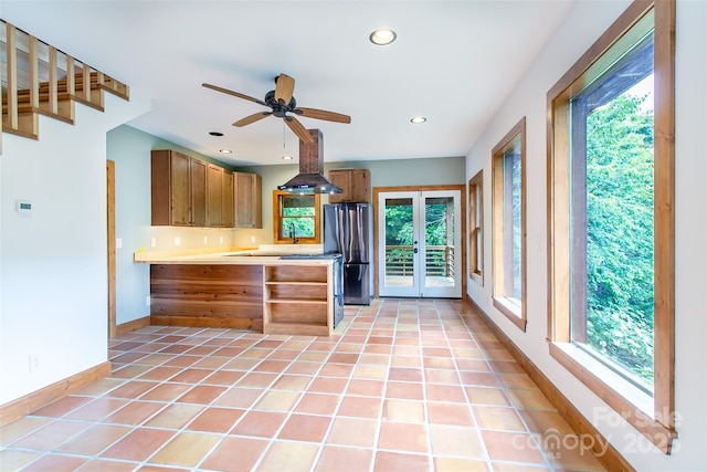 1146 Thomas Branch Rd, Marshall, NC 28753 - kitchen featuring freestanding refrigerator, island range hood, light countertops, baseboards, and brown cabinets