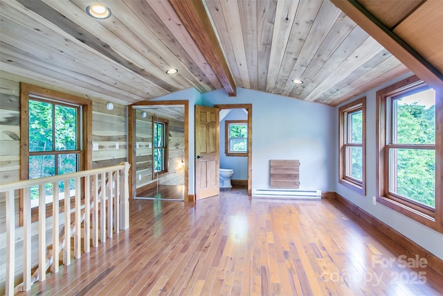 1146 Thomas Branch Rd, Marshall, NC 28753 - unfurnished living room featuring vaulted ceiling, baseboard heating, wood-type flooring, baseboards, and healthy amount of natural light