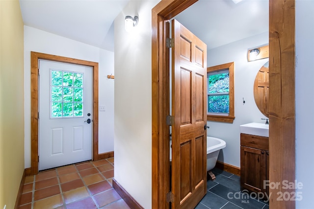 1146 Thomas Branch Rd, Marshall, NC 28753 - full bath featuring vanity, baseboards, a freestanding bath, and tile patterned floors