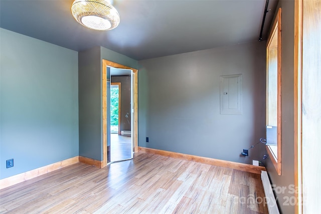 1146 Thomas Branch Rd, Marshall, NC 28753 - spare room with light wood-type flooring, electric panel, baseboards, and baseboard heating