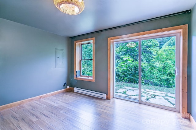 1146 Thomas Branch Rd, Marshall, NC 28753 - spare room featuring a baseboard heating unit, wood finished floors, and baseboards