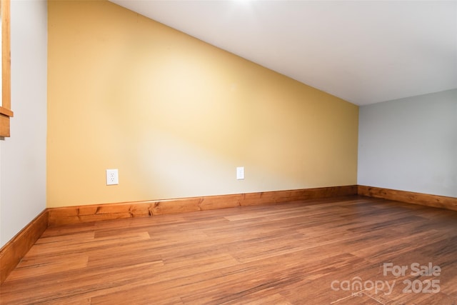1146 Thomas Branch Rd, Marshall, NC 28753 - unfurnished room featuring wood finished floors, vaulted ceiling, and baseboards