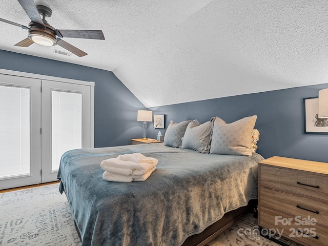 192 Shady Ln, Mill Spring, NC 28756 - bedroom with a textured ceiling, vaulted ceiling, and a ceiling fan