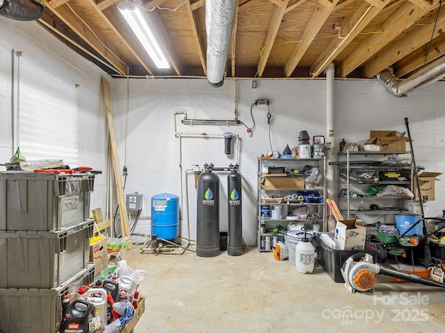 192 Shady Ln, Mill Spring, NC 28756 - unfinished basement with a water softener system, a water pressure tank, and concrete block wall