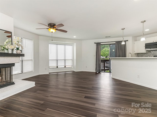 8183 Cedar Glen Dr, Charlotte, NC 28212 - unfurnished living room with ceiling fan, dark wood finished floors, a fireplace, recessed lighting, and baseboards
