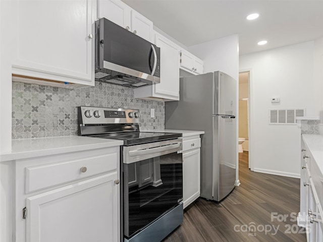 8183 Cedar Glen Dr, Charlotte, NC 28212 - kitchen featuring appliances with stainless steel finishes, dark wood-style flooring, light countertops, white cabinetry, and recessed lighting
