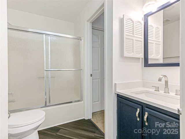 8183 Cedar Glen Dr, Charlotte, NC 28212 - full bathroom featuring vanity, shower / bath combination with glass door, toilet, and wood finished floors