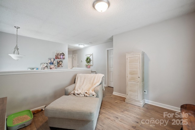 1912 8th St SE, Hickory, NC 28602 - sitting room featuring light wood-style flooring, baseboards, and a textured ceiling