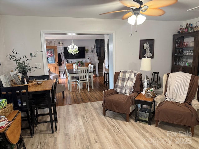 1895 Sandy Cir, Newton, NC 28658 - living area with a ceiling fan, light wood-style floors, and a chandelier