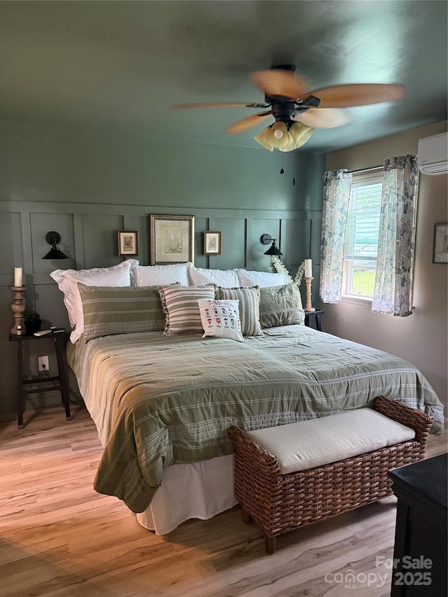 1895 Sandy Cir, Newton, NC 28658 - bedroom with a wall mounted AC, a decorative wall, wood finished floors, and ceiling fan