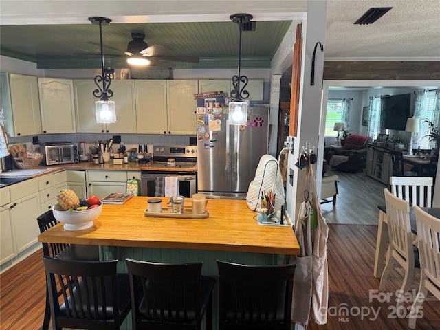 1895 Sandy Cir, Newton, NC 28658 - kitchen with appliances with stainless steel finishes, ceiling fan, dark wood-style flooring, ornamental molding, and wooden counters