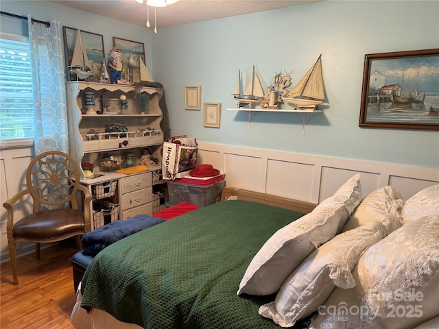 1895 Sandy Cir, Newton, NC 28658 - bedroom featuring wood finished floors, wainscoting, and a decorative wall