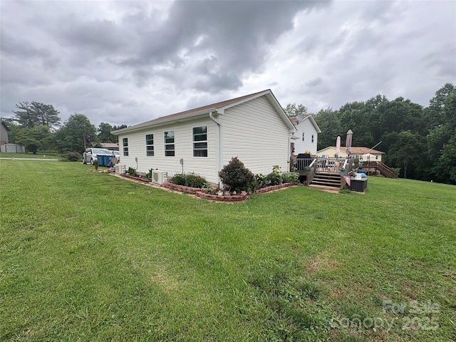 1895 Sandy Cir, Newton, NC 28658 - view of side of home with a deck, a lawn, and cooling unit