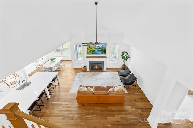 126 Still Creek Dr, Mooresville, NC 28115 - living area featuring plenty of natural light, light wood-type flooring, a fireplace with flush hearth, ceiling fan, and lofted ceiling