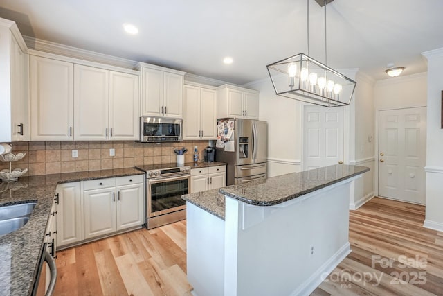10304 Squires Way Unit 18, Cornelius, NC 28031 - kitchen with appliances with stainless steel finishes, light wood-style floors, crown molding, decorative backsplash, and white cabinetry