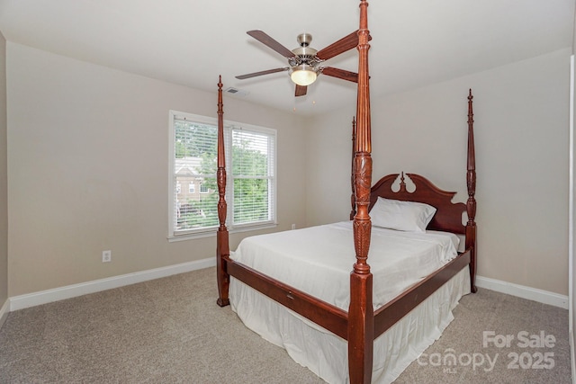 10304 Squires Way Unit 18, Cornelius, NC 28031 - bedroom with light colored carpet, baseboards, and a ceiling fan