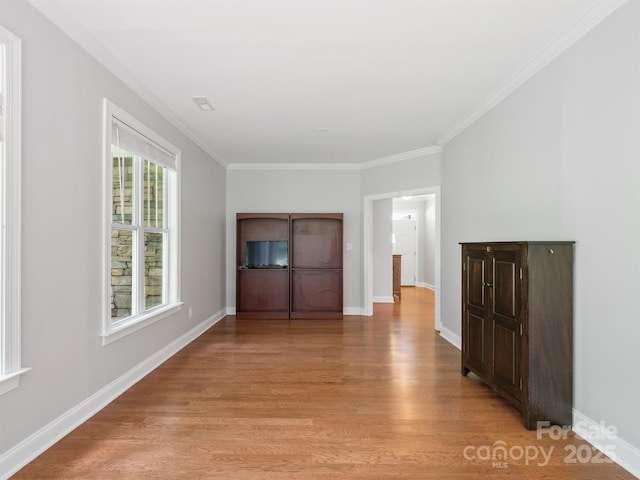 10875 Casetta Dr, Matthews, NC 28105 - unfurnished living room with crown molding and light wood-type flooring