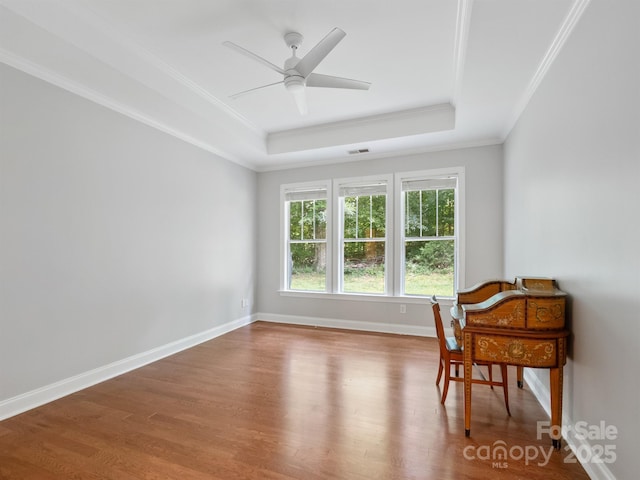 10875 Casetta Dr, Matthews, NC 28105 - sitting room featuring a raised ceiling, wood finished floors, ornamental molding, and ceiling fan