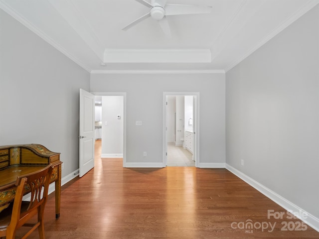 10875 Casetta Dr, Matthews, NC 28105 - bedroom with a tray ceiling, light wood-type flooring, and ornamental molding