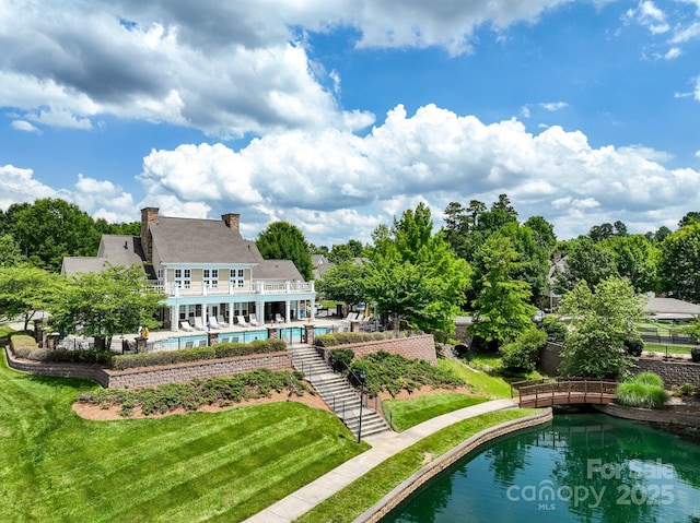 10875 Casetta Dr, Matthews, NC 28105 - back of property featuring an outdoor pool, a yard, a chimney, and stairway