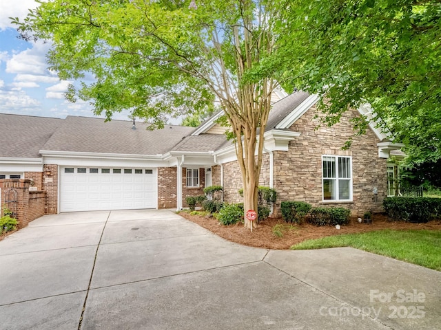 10875 Casetta Dr, Matthews, NC 28105 - view of front facade featuring driveway, an attached garage, stone siding, and roof with shingles