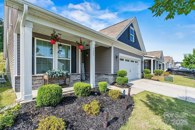 7809 Creek Park Dr, Denver, NC 28037 - view of front of home featuring covered porch, stone siding, driveway, an attached garage, and a front yard