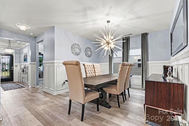 7809 Creek Park Dr, Denver, NC 28037 - dining room with a chandelier, light wood finished floors, a decorative wall, and a wainscoted wall
