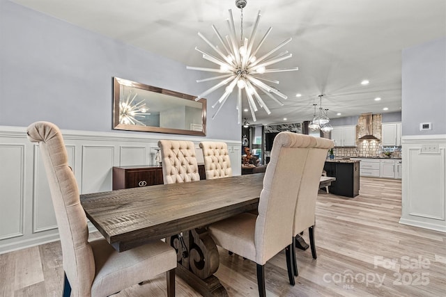 7809 Creek Park Dr, Denver, NC 28037 - dining space with a chandelier, recessed lighting, light wood-style floors, a wainscoted wall, and a decorative wall
