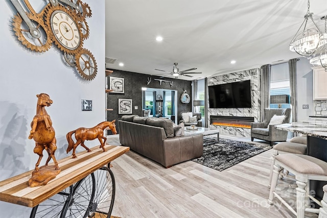 7809 Creek Park Dr, Denver, NC 28037 - living room with recessed lighting, light wood finished floors, a chandelier, a ceiling fan, and a high end fireplace