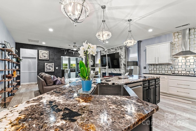 7809 Creek Park Dr, Denver, NC 28037 - kitchen with wall chimney range hood, open floor plan, a chandelier, light wood-type flooring, and recessed lighting