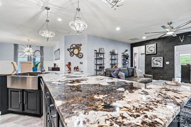 7809 Creek Park Dr, Denver, NC 28037 - kitchen featuring a chandelier, open floor plan, stone counters, ceiling fan, and a sink