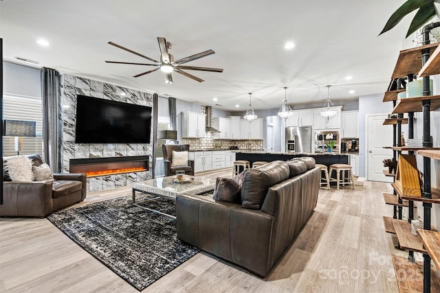 7809 Creek Park Dr, Denver, NC 28037 - living area featuring ceiling fan, light wood finished floors, a premium fireplace, and recessed lighting