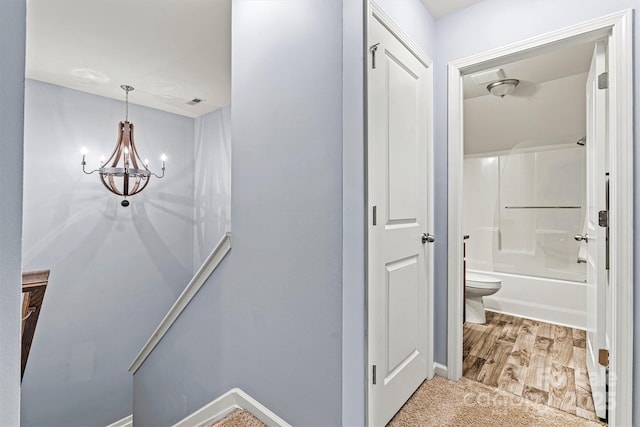 7809 Creek Park Dr, Denver, NC 28037 - hallway featuring a chandelier, baseboards, and carpet flooring