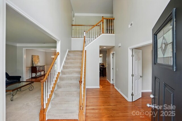 415 Glandon Ct, Fort Mill, SC 29708 - stairs featuring wood finished floors, crown molding, a towering ceiling, and baseboards